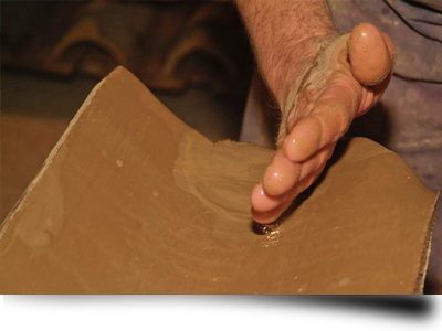 Hand making clay roof tiles